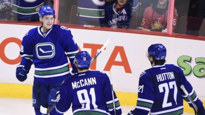 Feb 25, 2016; Vancouver, British Columbia, CAN; Vancouver Canucks forward Jake Virtanen (18) celebrates his goal against Ottawa Sentators goaltender Craig Anderson (41) (not pictured) with forward Jared McCann (91) and defenseman Ben Hutton (27) during the third period at Rogers Arena. The Vancouver Canucks won 5-3. Mandatory Credit: Anne-Marie Sorvin-USA TODAY Sports