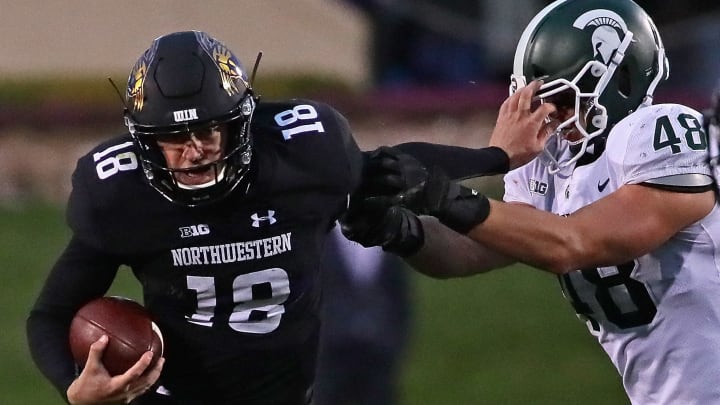 EVANSTON, IL – OCTOBER 28: Clayton Thorson #18 of the Northwestern Wildcats holds off Kenny Willekes #48 of the Michigan State Spartans as he runs for yardage at Ryan Field on October 28, 2017 in Evanston, Illinois. Northwestern defeated Michigan State 39-31 in triple overtime.(Photo by Jonathan Daniel/Getty Images)