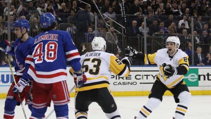 NEW YORK, NEW YORK - MARCH 25: Teddy Blueger #53 of the Pittsburgh Penguins scores a shorthanded goal at 13:12 of the second period against Alexandar Georgiev #40 of the New York Rangers and is joined by Brian Dumoulin #8 (r) at Madison Square Garden on March 25, 2019 in New York City. (Photo by Bruce Bennett/Getty Images)
