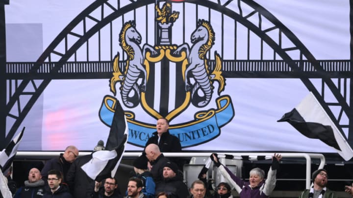 NEWCASTLE UPON TYNE, ENGLAND - JANUARY 15: A flag showing the Tyne Bridge is pictured alongside fans in the Gallowgate End during the Premier League match between Newcastle United and Watford at St. James Park on January 15, 2022 in Newcastle upon Tyne, England. (Photo by Stu Forster/Getty Images)