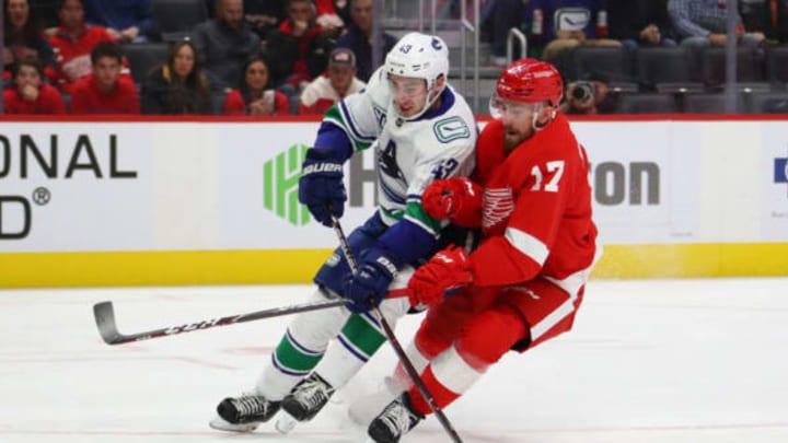DETROIT, MICHIGAN – OCTOBER 22: Quinn Hughes #43 of the Vancouver Canucks tries to get around the stick of Filip Hronek #17 of the Detroit Red Wings during the third period at Little Caesars Arena on October 22, 2019 in Detroit, Michigan. Vancouver won the game 5-2. (Photo by Gregory Shamus/Getty Images)