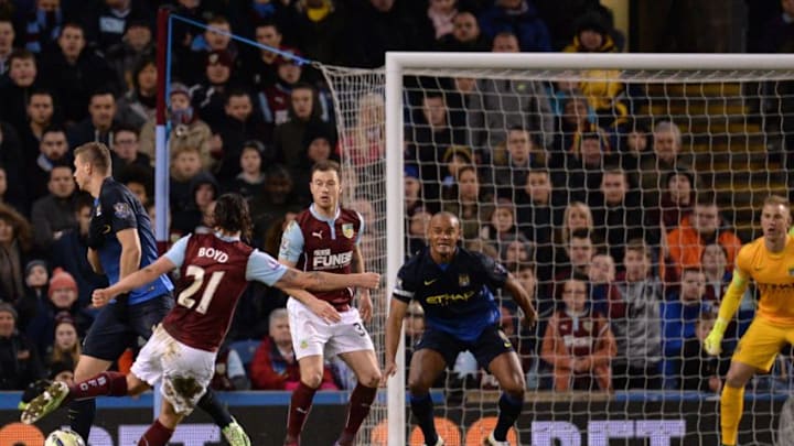 Burnley's Scottish midfielder George Boyd (L) shoots to score the opening goal of the English Premier League football match between Burnley and Manchester City at Turf Moor in Burnley, north west England, on March 14, 2015. AFP PHOTO / OLI SCARFFRESTRICTED TO EDITORIAL USE. No use with unauthorized audio, video, data, fixture lists, club/league logos or live services. Online in-match use limited to 45 images, no video emulation. No use in betting, games or single club/league/player publications. (Photo credit should read OLI SCARFF/AFP/Getty Images)