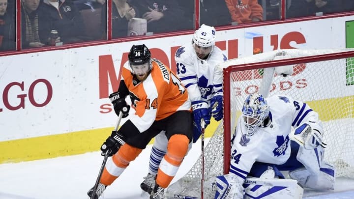 Jan 19, 2016; Philadelphia, PA, USA; Philadelphia Flyers center Sean Couturier (14) carries the puck against Toronto Maple Leafs center Nazem Kadri (43) and goalie James Reimer (34) during the third period at Wells Fargo Center. The Maple Leafs defeated the Flyers, 3-2. Mandatory Credit: Eric Hartline-USA TODAY Sports