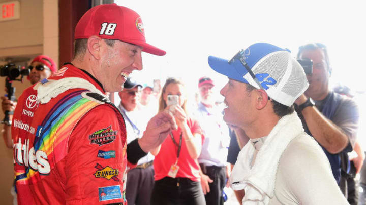 JOLIET, IL - JULY 01: Kyle Busch, driver of the #18 Skittles Red White and Blue Toyota, speaks with Kyle Larson, driver of the #42 Credit One Bank Chevrolet (Photo by Jared C. Tilton/Getty Images)