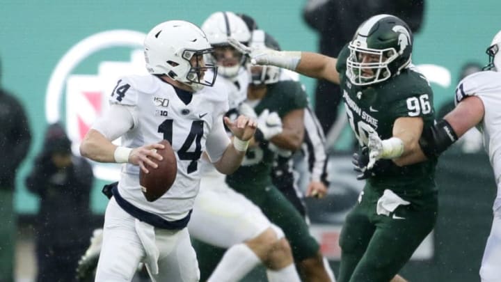 EAST LANSING, MI - OCTOBER 26: Quarterback Sean Clifford #14 of the Penn State Nittany Lions looks to pass the ball against defensive end Jacub Panasiuk #96 of the Michigan State Spartans during the first half at Spartan Stadium on October 26, 2019 in East Lansing, Michigan. Penn State defeated Michigan State 28-7. (Photo by Duane Burleson/Getty Images)