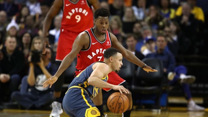 OAKLAND, CA - DECEMBER 12: Stephen Curry #30 of the Golden State Warriors dribbles on his knees while being guarded by Kyle Lowry #7 of the Toronto Raptors at ORACLE Arena on December 12, 2018 in Oakland, California. NOTE TO USER: User expressly acknowledges and agrees that, by downloading and or using this photograph, User is consenting to the terms and conditions of the Getty Images License Agreement. (Photo by Ezra Shaw/Getty Images)