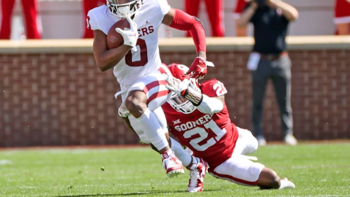 Apr 24, 2021; Norman, Oklahoma, USA; Oklahoma Sooners running back Eric Gray (0) runs with the ball as Oklahoma Sooners cornerback Kendall Dennis (21) defends during the spring game at Gaylord Family-Oklahoma Memorial Stadium. Mandatory Credit: Kevin Jairaj-USA TODAY Sports