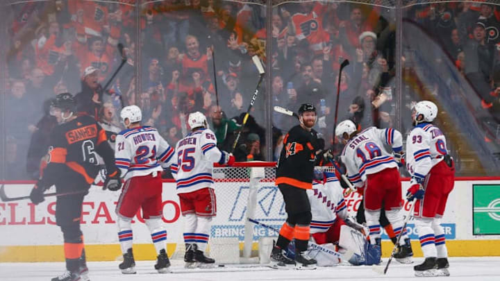 PHILADELPHIA, PA - DECEMBER 23: Travis Sanheim #6 and Sean Couturier #14 of the Philadelphia Flyers react in front of Brett Howden #21, Ryan Lindgren #55, Marc Staal #18, and Mika Zibanejad #93 of the New York Rangers after a goal by Sanheim in the final seconds of the second period at the Wells Fargo Center on December 23, 2019 in Philadelphia, Pennsylvania. (Photo by Mitchell Leff/Getty Images)