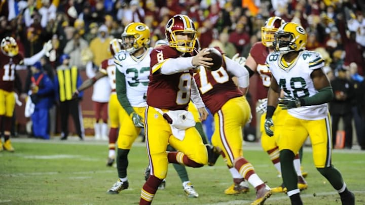 Jan 10, 2016; Landover, MD, USA; Washington Redskins quarterback Kirk Cousins (8) scores a touchdown in front of Green Bay Packers linebacker Joe Thomas (48) during the second half in a NFC Wild Card playoff football game at FedEx Field. Mandatory Credit: Brad Mills-USA TODAY Sports