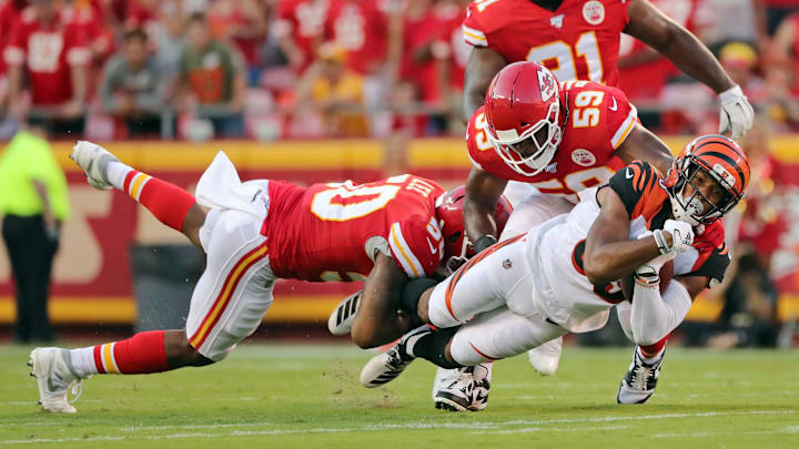 Aug 10, 2019; Kansas City, MO, USA; Cincinnati Bengals wide receiver Tyler Boyd (83) is tackled by Kansas City Chiefs linebacker Darius Harris (50) and linebacker Reggie Ragland (59) during the first half at Arrowhead Stadium. Mandatory Credit: Jay Biggerstaff-USA TODAY Sports