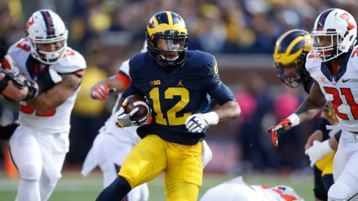 ANN ARBOR, MI - OCTOBER 22: Chris Evans #12 of the Michigan Wolverines looks for running room while playing the Illinois Fighting Illini on October 22, 2016 at Michigan Stadium in Ann Arbor, Michigan. Michigan won the game 41-8. (Photo by Gregory Shamus/Getty Images)