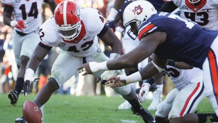 Nov 14, 2015; Auburn, AL, USA; Georgia Bulldogs linebacker Tim Kimbrough (42) and Auburn Tigers lineman Shon Coleman (72) reach for a fumble on the goal line during the fourth quarter at Jordan Hare Stadium. The Bulldogs recovered and beat the Tigers 20-13. Mandatory Credit: John Reed-USA TODAY Sports