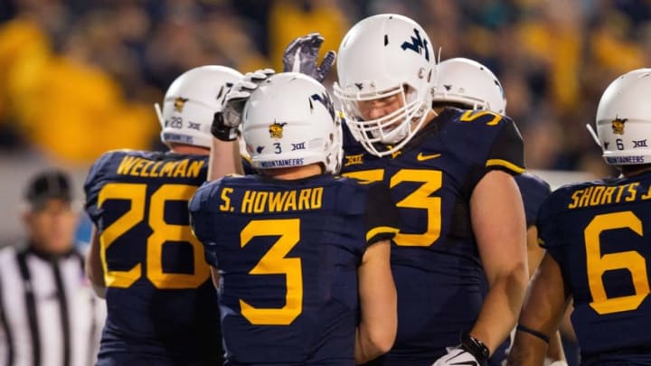 Nov 5, 2016; Morgantown, WV, USA; West Virginia Mountaineers quarterback Skyler Howard (3) celebrates with teammates after running for a touchdown during the first quarter against the Kansas Jayhawks at Milan Puskar Stadium. Mandatory Credit: Ben Queen-USA TODAY Sports