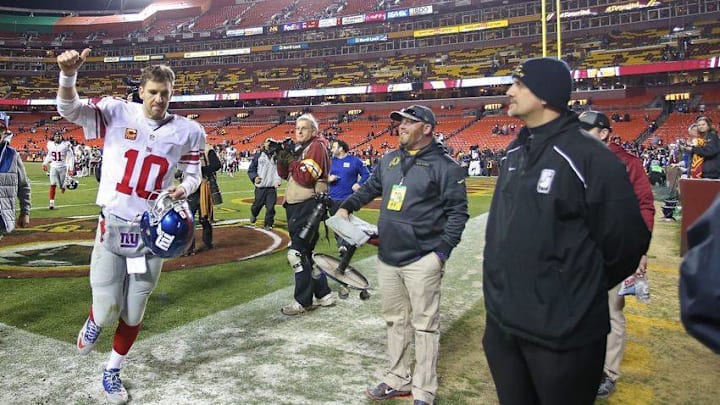 Jan 1, 2017; Landover, MD, USA; New York Giants quarterback Eli Manning (10) waves to fans while running off the field after the Giants