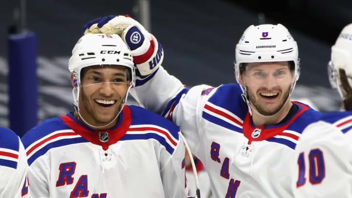 UNIONDALE, NEW YORK – APRIL 09: K’Andre Miller #79 of the New York Rangers (L) celebrates his third period goal against the New York Islanders and is joined by Jacob Trouba #8 (R) at Nassau Coliseum on April 09, 2021 in Uniondale, New York. (Photo by Bruce Bennett/Getty Images)