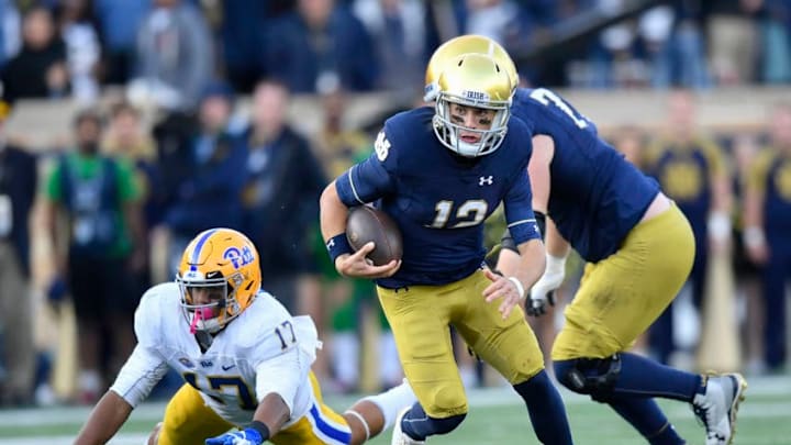 SOUTH BEND, IN - OCTOBER 13: Ian Book #12 of the Notre Dame Fighting Irish scramble to avoid the tackle from Rashad Weaver #17 of the Pittsburgh Panthers in the second half at Notre Dame Stadium on October 13, 2018 in South Bend, Indiana. (Photo by Quinn Harris/Getty Images)