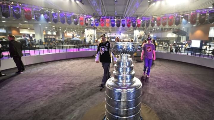 Jan 29, 2016; Nashville, TN, USA; Hockey fans walk toward the Stanley Cup for a picture at the fan fair prior to the 2016 NHL All Star Game at Bridgestone Arena. Mandatory Credit: Christopher Hanewinckel-USA TODAY Sports