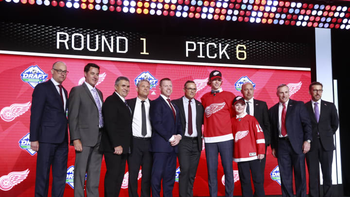 VANCOUVER, BRITISH COLUMBIA – JUNE 21: Moritz Seider (fifth from right), sixth overall pick of the Detroit Red Wings, pose for a group photo onstage with team personnel during the first round of the 2019 NHL Draft at Rogers Arena on June 21, 2019 in Vancouver, Canada. (Photo by Jeff Vinnick/NHLI via Getty Images)