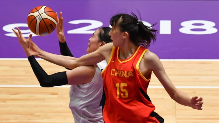 (L-R) Unified Korea’s Park Jisu and China’s Han Xu compete for the ball during the women’s gold medal basketball match between Unified Korea and China at the 2018 Asian Games in Jakarta on September 1, 2018. (Photo by Anthony WALLACE / AFP) (Photo credit should read ANTHONY WALLACE/AFP/Getty Images)