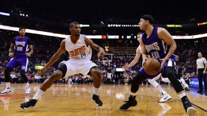 Apr 11, 2016; Phoenix, AZ, USA; Sacramento Kings guard Seth Curry (30) handles the ball against Phoenix Suns guard Ronnie Price (14) in the first half at Talking Stick Resort Arena. Mandatory Credit: Jennifer Stewart-USA TODAY Sports