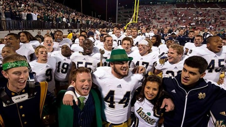 Oct. 27, 2012; Norman, OK, USA; Notre Dame Fighting Irish linebacker Carlo Calabrese (44) sings the Notre Dame alma mater with the Notre Dame leprechaun after Notre Dame defeated the Oklahoma Sooners 30-13 at Oklahoma Memorial Stadium. Mandatory Credit: Matt Cashore-USA TODAY Sports