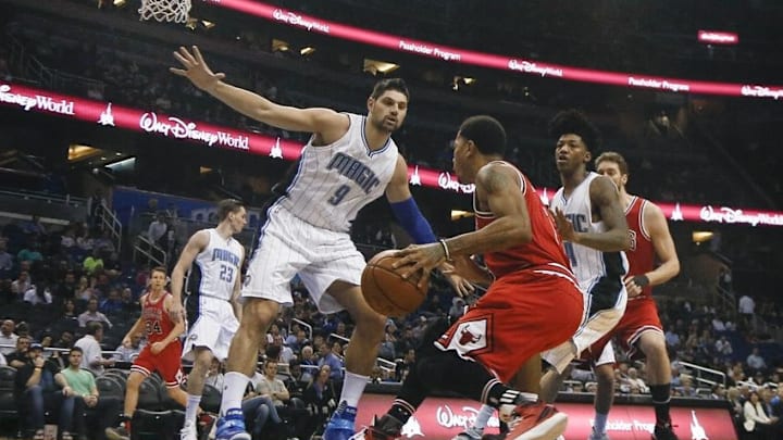 Mar 2, 2016; Orlando, FL, USA; Orlando Magic center Nikola Vucevic (9) and guard Elfrid Payton (4) block the path of Chicago Bulls guard Derrick Rose (center) during the first quarter of a basketball game at Amway Center. Mandatory Credit: Reinhold Matay-USA TODAY Sports