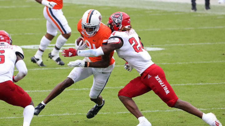 Oct 10, 2020; Charlottesville, Virginia, USA; Virginia Cavaliers wide receiver Lavel Davis Jr. (81) runs with the ball as North Carolina State Wolfpack cornerback Malik Dunlap (24) makes the tackle in the first quarter at Scott Stadium. Mandatory Credit: Geoff Burke-USA TODAY Sports