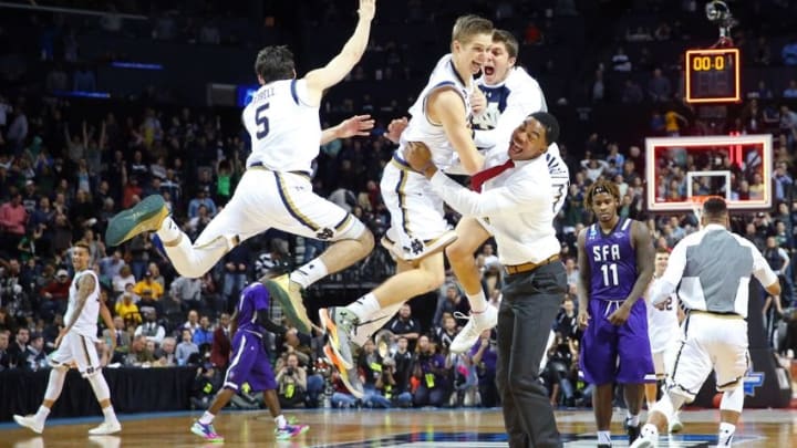 Mar 20, 2016; Brooklyn, NY, USA; Notre Dame Fighting Irish guard Rex Pflueger (middle) celebrates with his teammates as time expires after tipping in the winning basket against the Stephen F. Austin Lumberjacks in the second round of the 2016 NCAA Tournament at Barclays Center. Mandatory Credit: Anthony Gruppuso-USA TODAY Sports