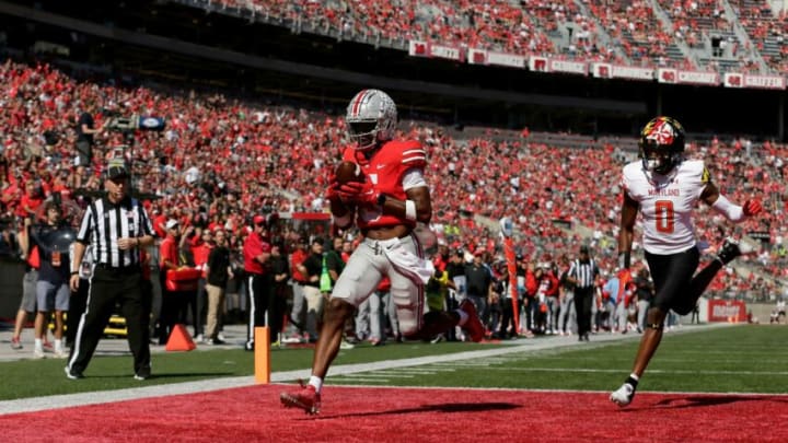 Ohio State Buckeyes wide receiver Garrett Wilson (5) scores a touchdown with Maryland Terrapins linebacker Terrence Lewis (0) trailing during the second half of Saturday's NCAA Division I football game at Ohio Stadium in Columbus on October 9, 2021.Osu21mary Bjp 1422