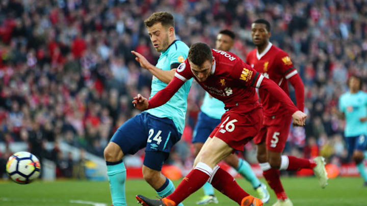 LIVERPOOL, ENGLAND - APRIL 14: Andy Robertson of Liverpool shoots while under pressure from Ryan Fraser of AFC Bournemouth during the Premier League match between Liverpool and AFC Bournemouth at Anfield on April 14, 2018 in Liverpool, England. (Photo by Clive Brunskill/Getty Images)