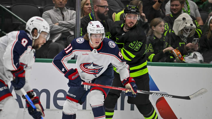 Oct 30, 2023; Dallas, Texas, USA; Columbus Blue Jackets center Kent Johnson (91) and Dallas Stars center Matt Duchene (95) chase the puck during the second period at the American Airlines Center. Mandatory Credit: Jerome Miron-USA TODAY Sports