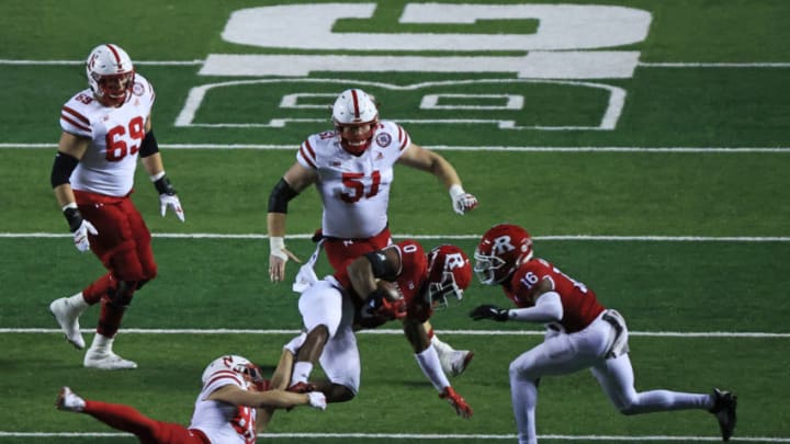 PISCATAWAY, NJ - DECEMBER 18: Oliver Martin #89 of the Nebraska Cornhuskers tackles Christian Izien #0 of the Rutgers Scarlet Knights after Izien picked up a interception during the third quarter at SHI Stadium on December 18, 2020 in Piscataway, New Jersey. Nebraska defeated Rutgers 28-21. (Photo by Corey Perrine/Getty Images)