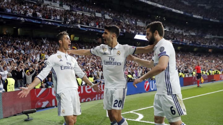 MADRID, SPAIN – MAY 02: Cristiano Ronaldo (L) of Real Madrid celebrates with Marco Asensio (C) and Nacho Fernandez their team’s second goal during the UEFA Champions League Semi Final first leg match between Real Madrid CF and Club Atletico de Madrid at Estadio Santiago Bernabeu on May 2, 2017 in Madrid, Spain. (Photo by Angel Martinez/Real Madrid via Getty Images)