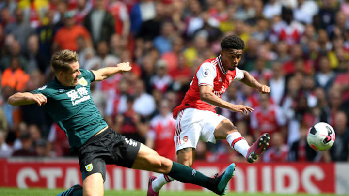 LONDON, ENGLAND - AUGUST 17: Reiss Nelson of Arsenal shoots under pressure from James Tarkowski of Burnley during the Premier League match between Arsenal FC and Burnley FC at Emirates Stadium on August 17, 2019 in London, United Kingdom. (Photo by Michael Regan/Getty Images)