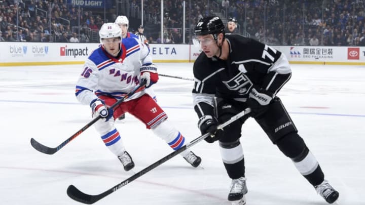 LOS ANGELES, CA - DECEMBER 10: Jeff Carter #77 of the Los Angeles Kings skates with the puck with pressure from Ryan Strome #16 of the New York Rangers during the second period at STAPLES Center on December 10, 2019 in Los Angeles, California. (Photo by Juan Ocampo/NHLI via Getty Images)