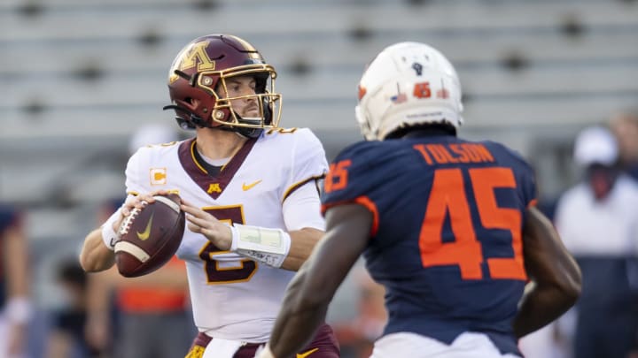 Nov 7, 2020; Champaign, Illinois, USA; Minnesota Golden Gophers quarterback Tanner Morgan (L) looks to pass while pressured by Illinois Fighting Illini linebacker Khalan Tolson (45) during the first half at Memorial Stadium. Mandatory Credit: Patrick Gorski-USA TODAY Sports