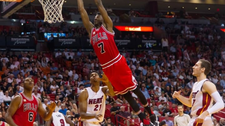 Apr 7, 2016; Miami, FL, USA; Chicago Bulls guard Justin Holiday (7) dunks the ball past Miami Heat center Hassan Whiteside (21) during the first half at American Airlines Arena. Mandatory Credit: Steve Mitchell-USA TODAY Sports