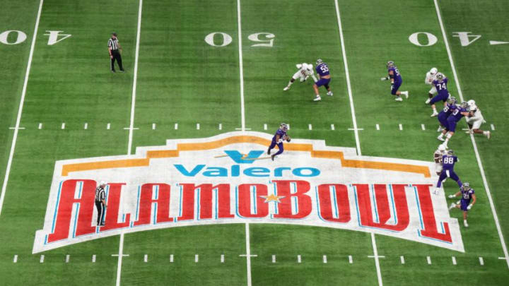Dec 29, 2022; San Antonio, Texas, USA; A general overall view as Washington Huskies quarterback Michael Penix Jr. (9) throws the ball on the 2022 Valero Alamo Bowl logo at midfield against the Washington Huskies at Alamodome. Mandatory Credit: Kirby Lee-USA TODAY Sports