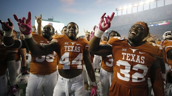 Oct 29, 2016; Austin, TX, USA; Texas Longhorns players Brando Hodges (58), Quincy Vasser (44), and Malcolm Roach (32) celebrate after defeating the Baylor Bears 35-34 at Darrell K Royal-Texas Memorial Stadium. Mandatory Credit: Erich Schlegel-USA TODAY Sports