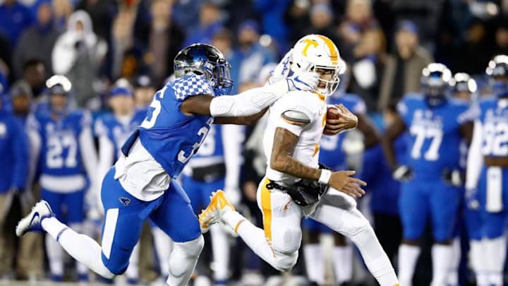 LEXINGTON, KY - OCTOBER 28: Jarrett Guarnanto of the Tennessee Volunteers runs with the ball while defended by Denzil Ware