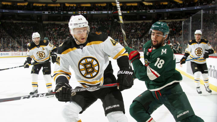 ST. PAUL, MN - APRIL 04: Steven Kampfer #44 of the Boston Bruins and Jordan Greenway #18 of the Minnesota Wild race after a loose puck during a game at Xcel Energy Center on April 4, 2019 in St. Paul, Minnesota.(Photo by Bruce Kluckhohn/NHLI via Getty Images)