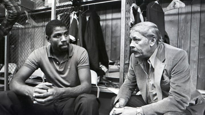 Earvin Magic Johnson the Los Angeles Lakers speaks with Laker owner Jerry Buss (Photo by Steve Dykes/Getty Images)