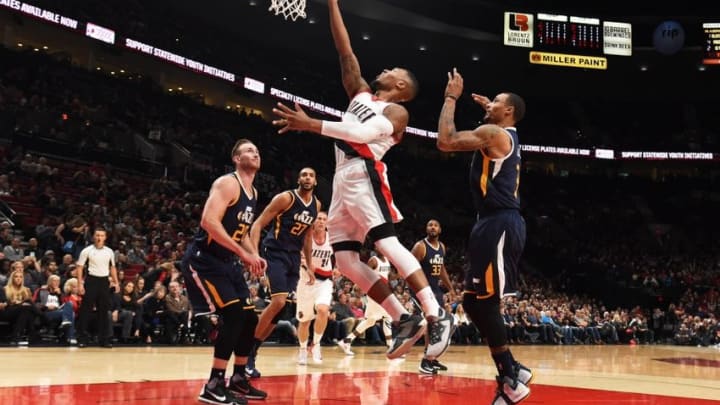 Oct 3, 2016; Portland, OR, USA; Portland Trail Blazers guard Damian Lillard (0) drives to the basket on Utah Jazz guard Rodney Hood (5) and forward Gordon Hayward (20) during the first quarter at the Moda Center at the Rose Quarter. Mandatory Credit: Steve Dykes-USA TODAY Sports