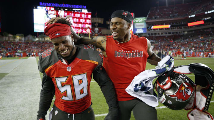 TAMPA, FL – NOVEMBER 27: Kwon Alexander #58 of the Tampa Bay Buccaneers celebrates with a teammate after the game against the Seattle Seahawks at Raymond James Stadium on November 27, 2016 in Tampa, Florida. The Buccaneers defeated the Seahawks 14-5. (Photo by Joe Robbins/Getty Images)