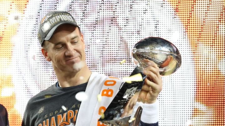 Feb 7, 2016; Santa Clara, CA, USA; Denver Broncos quarterback Peyton Manning (18) looks at the Vince Lombardi Trophy after beating the Carolina Panthers in Super Bowl 50 at Levi