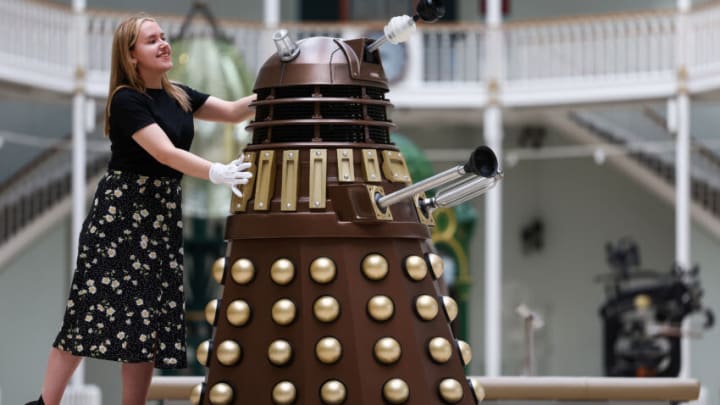 EDINBURGH, SCOTLAND - JULY 21: Liv Mullen from the National Museum of Scotland poses with a Dalek ahead of the new exhibition, 'Doctor Who Worlds of Wonder', on July 21, 2022 in Edinburgh, Scotland. This exhibition, which runs from 10 December 2022 to 30 April 2023, explores the science behind the global hit television series Doctor Who and will give fans a chance to experience the Doctor's adventures from a scientific perspective. (Photo by Jeff J Mitchell/Getty Images)