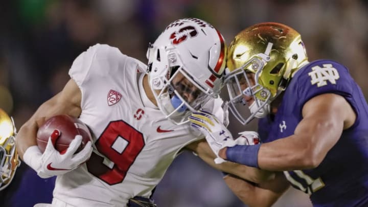 SOUTH BEND, IN - SEPTEMBER 29: Osiris St. Brown #9 of the Stanford Cardinal runs the ball as Alohi Gilman #11 of the Notre Dame Fighting Irish comes in for the tackle at Notre Dame Stadium on September 29, 2018 in South Bend, Indiana. (Photo by Michael Hickey/Getty Images)