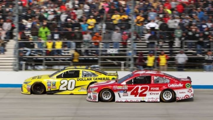 May 15, 2016; Dover, DE, USA; NASCAR Sprint Cup Series driver Kyle Larson (42) races alongside of driver Matt Kenseth (20) during the AAA 400 Drive For Autism at Dover International Speedway. Mandatory Credit: Matthew O