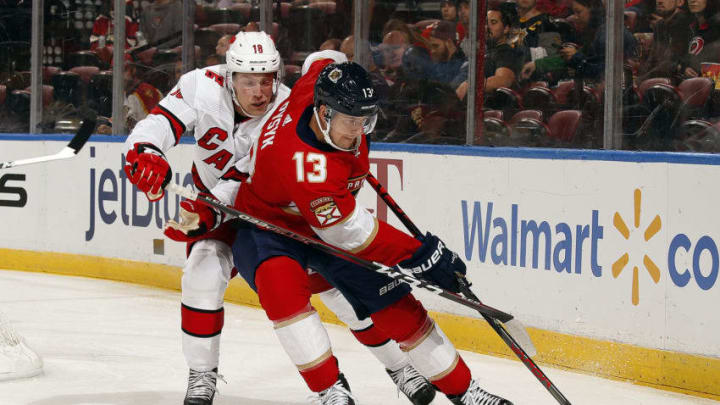 SUNRISE, FL - OCT. 8: Mark Pysyk #13 of the Florida Panthers skates with the puck against Ryan Dzingel #18 of the Carolina Hurricanes at the BB&T Center on October 8, 2019 in Sunrise, Florida. (Photo by Eliot J. Schechter/NHLI via Getty Images)