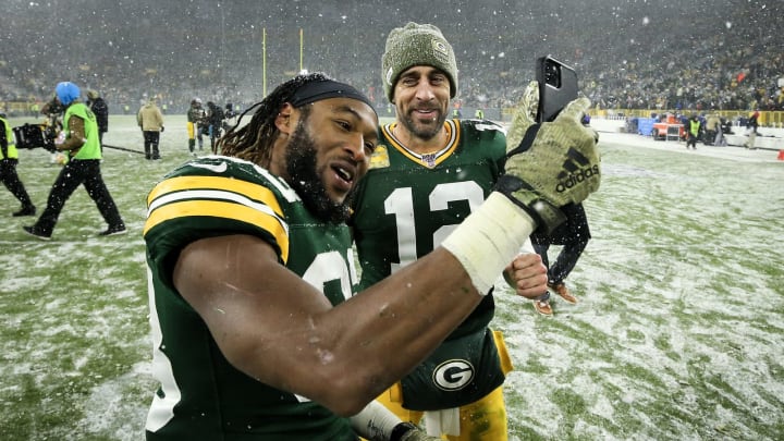 Aaron Jones #33 and Aaron Rodgers #12 of the Green Bay Packers  (Photo by Dylan Buell/Getty Images)